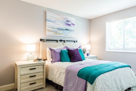 a bedroom with a bed and two night stands